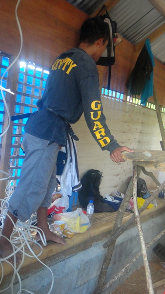 Joery installing wiring at the nipa hut