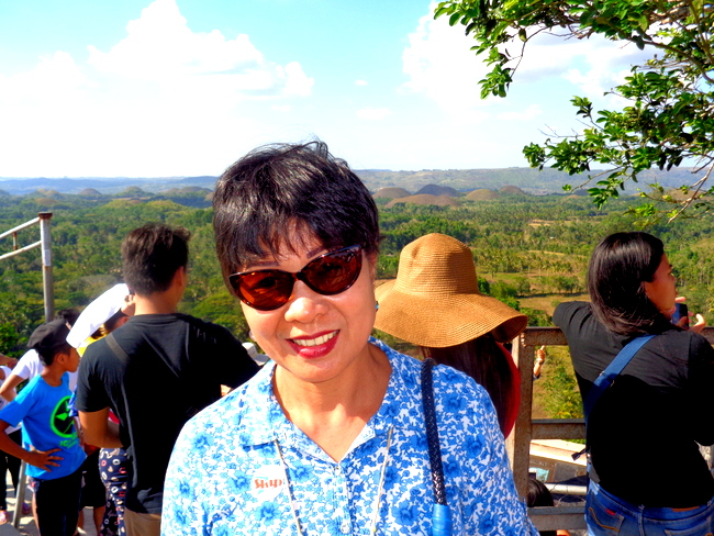 my spouse and tourists by chocolate hills bohol