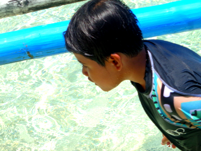 nephew checking out puka shell beach boracay